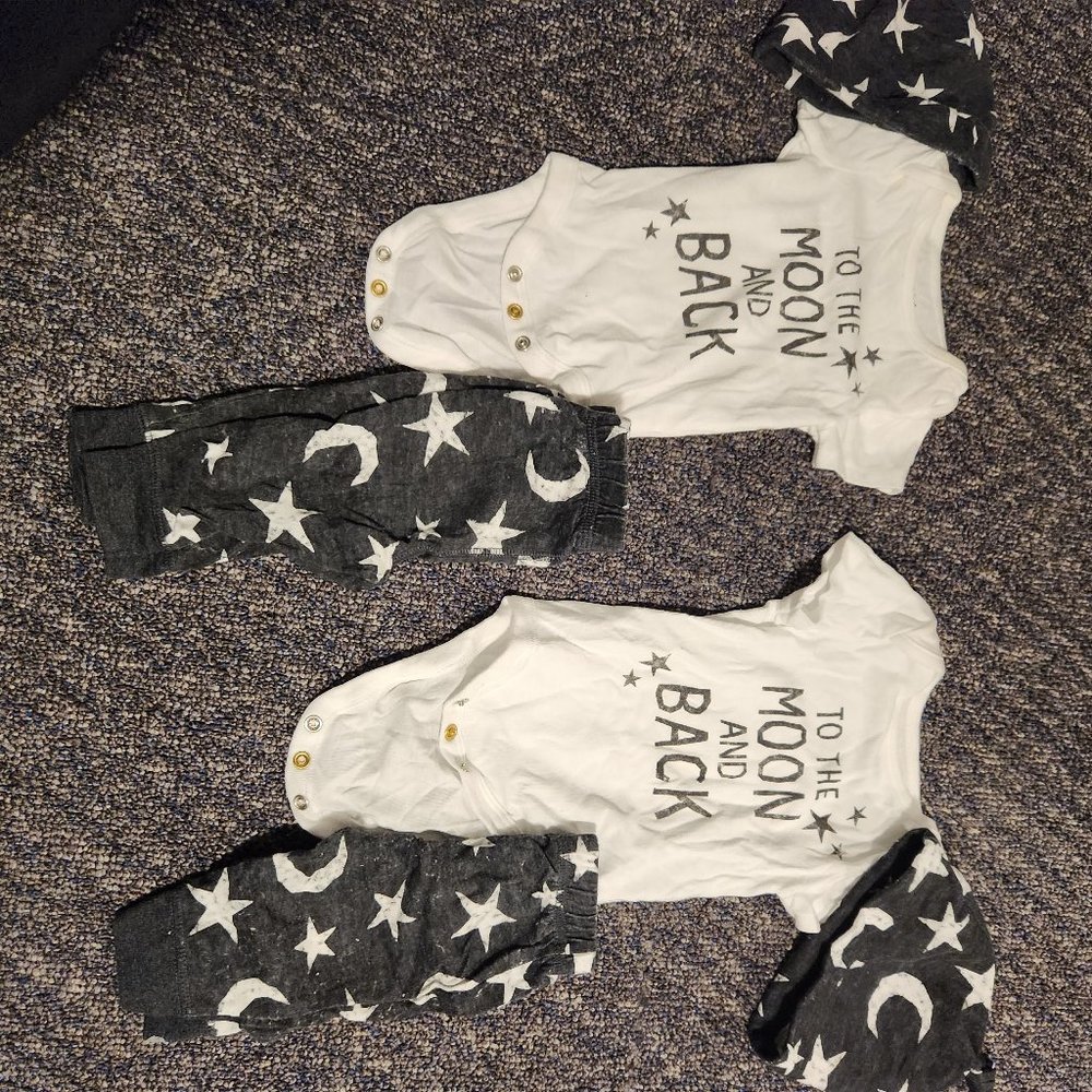 6 matching twin sets and 2 pair of black pants. NEWBORN SIZE. GOOD CONDITION
